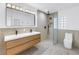Modern bathroom featuring a double sink vanity, sleek fixtures, and a spacious glass-enclosed shower at 412 Mira Vista Dr, Dunedin, FL 34698
