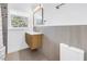 Modern bathroom featuring a sleek wooden vanity, neutral walls, and mosaic shower tile at 412 Mira Vista Dr, Dunedin, FL 34698