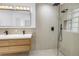 Modern bathroom featuring a double sink vanity, sleek fixtures, and a spacious glass-enclosed shower at 412 Mira Vista Dr, Dunedin, FL 34698