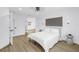 Comfortable bedroom with modern lighting, fresh white linens, and a calming atmosphere at 412 Mira Vista Dr, Dunedin, FL 34698
