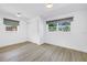 Bright bedroom with light wood floors, fresh paint, and double windows at 412 Mira Vista Dr, Dunedin, FL 34698