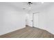Neutral bedroom featuring wood-look floors, white trim, and closet and bathroom access at 412 Mira Vista Dr, Dunedin, FL 34698