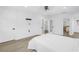 Bright bedroom with modern lighting, fresh white linens, and an ensuite bathroom at 412 Mira Vista Dr, Dunedin, FL 34698