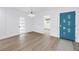Entryway showcasing the front door and front room, plus light-colored hard wood-look floors at 412 Mira Vista Dr, Dunedin, FL 34698