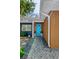 Stylish front entrance features a bright blue door with unique window accents and stone pathway at 412 Mira Vista Dr, Dunedin, FL 34698
