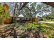 Charming single-story home with a well-manicured lawn and inviting landscaping at 412 Mira Vista Dr, Dunedin, FL 34698