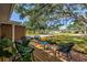 Inviting front yard with cozy deck seating area, complemented by beautiful landscaping and a modern design at 412 Mira Vista Dr, Dunedin, FL 34698