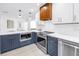 Kitchen with white counters, navy blue cabinets and stainless steel appliances at 412 Mira Vista Dr, Dunedin, FL 34698