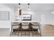 Kitchen featuring a large island with barstool seating and modern lighting at 412 Mira Vista Dr, Dunedin, FL 34698