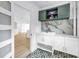 Laundry room features patterned tile, marble backsplash and custom cabinets at 412 Mira Vista Dr, Dunedin, FL 34698