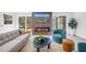 Bright living room with a decorative fireplace, modern furniture, and a sliding glass door to the outdoor deck at 412 Mira Vista Dr, Dunedin, FL 34698