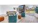 Open-concept living room featuring contemporary furniture, a decorative fireplace, and a sliding glass door to the outdoor deck at 412 Mira Vista Dr, Dunedin, FL 34698