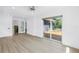 Spacious main bedroom with sliding doors opening to an outdoor wooden deck and backyard at 412 Mira Vista Dr, Dunedin, FL 34698
