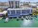 Aerial view of waterfront condo with a community pool and boat docks at 415 Island Way # 507, Clearwater Beach, FL 33767