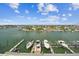 This aerial view shows multiple boats docked at a waterfront property with beautiful landscaping at 415 Island Way # 507, Clearwater Beach, FL 33767