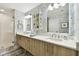 Bathroom featuring double sinks with a light wood vanity and a glass-enclosed shower at 415 Island Way # 507, Clearwater Beach, FL 33767