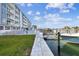 Condo building with water access, boat dock, and lush lawn at 415 Island Way # 507, Clearwater Beach, FL 33767
