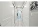 Hallway with tiled floors and a view of the bathroom, framed by closet doors on either side at 415 Island Way # 507, Clearwater Beach, FL 33767