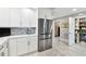 Bright kitchen features white cabinetry, stainless steel refrigerator, and a walk-in pantry at 415 Island Way # 507, Clearwater Beach, FL 33767