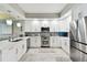 Contemporary kitchen featuring white cabinetry, stainless steel appliances, and ample counter space at 415 Island Way # 507, Clearwater Beach, FL 33767