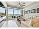This living room has a view of the water, a sofa, and artwork on the wall at 415 Island Way # 507, Clearwater Beach, FL 33767