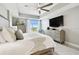 This primary bedroom features a king bed, ceiling fan, and a mounted flatscreen television at 415 Island Way # 507, Clearwater Beach, FL 33767