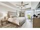 This primary bedroom features tray ceilings, tile floors, a ceiling fan and a view of the water at 415 Island Way # 507, Clearwater Beach, FL 33767