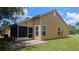 View of the backyard featuring a screened-in porch, patio and an exterior view of the home at 4206 Revere Cir, New Port Richey, FL 34653