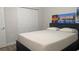 Bedroom featuring a large bed with a closet and colorful paintings on the wall at 4206 Revere Cir, New Port Richey, FL 34653