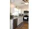 Well-equipped kitchen with stainless steel dishwasher and microwave, and bright white cabinets at 4206 Revere Cir, New Port Richey, FL 34653