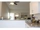 Open kitchen with granite countertops and a view to the living room and screened lanai at 4206 Revere Cir, New Port Richey, FL 34653