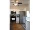Modern kitchen features stainless steel appliances, white cabinetry and granite countertops at 4206 Revere Cir, New Port Richey, FL 34653