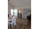 Cozy living room featuring hardwood floors, dining set, and sliding doors to the outside at 4206 Revere Cir, New Port Richey, FL 34653