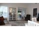 Bright living room features comfortable seating, large windows, and sliding glass door to lanai at 4206 Revere Cir, New Port Richey, FL 34653