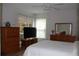 Spacious main bedroom with hardwood floors, a ceiling fan, a dresser, and ample closet space at 4206 Revere Cir, New Port Richey, FL 34653