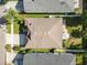 Aerial view of a home showing the roof, driveway, and backyard with an outdoor seating area at 4510 Beaumaris Dr, Land O Lakes, FL 34638