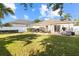 Lush backyard with patio, seating, and lush green grass and a privacy fence at 4510 Beaumaris Dr, Land O Lakes, FL 34638