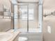 Clean and bright bathroom with a shower and tub combo featuring sleek glass doors and tile surround, offering relaxation at 4510 Beaumaris Dr, Land O Lakes, FL 34638