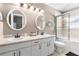 Bathroom featuring double sinks, white cabinets, modern fixtures, and a shower-tub combo, creating functionality at 4510 Beaumaris Dr, Land O Lakes, FL 34638