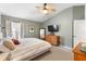 Relaxing bedroom with a ceiling fan, soft green walls, and a view of the ensuite bathroom, providing comfort at 4510 Beaumaris Dr, Land O Lakes, FL 34638