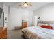 Bright bedroom featuring a modern ceiling fan, large windows, and an en suite bathroom, providing relaxation at 4510 Beaumaris Dr, Land O Lakes, FL 34638