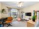 Comfortable bedroom featuring a ceiling fan, large window and modern furniture at 4510 Beaumaris Dr, Land O Lakes, FL 34638