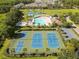 Aerial view of community amenities featuring tennis courts, basketball courts and a large pool with lounge area at 4510 Beaumaris Dr, Land O Lakes, FL 34638