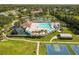 Aerial view of community amenities showcasing a pool, tennis courts, a playground, and basketball courts at 4510 Beaumaris Dr, Land O Lakes, FL 34638