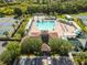 Aerial view of the community pool with covered lounge areas and a playground for children at 4510 Beaumaris Dr, Land O Lakes, FL 34638