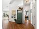 Inviting foyer with hardwood floors and hall tree, offering a glimpse into the open floor plan and primary bedroom at 4510 Beaumaris Dr, Land O Lakes, FL 34638