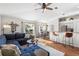 Open-concept living room with a cozy blue sectional and hardwood floors at 4510 Beaumaris Dr, Land O Lakes, FL 34638
