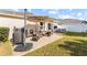 Outdoor patio area with grilling equipment, seating area, and shade umbrella at 4510 Beaumaris Dr, Land O Lakes, FL 34638