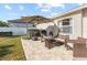 Spacious patio area features comfortable seating, an umbrella, and grilling area at 4510 Beaumaris Dr, Land O Lakes, FL 34638