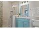 Updated bathroom with granite counters, custom vanity, glass shower, and modern lighting at 511 Windward Psge, Clearwater Beach, FL 33767